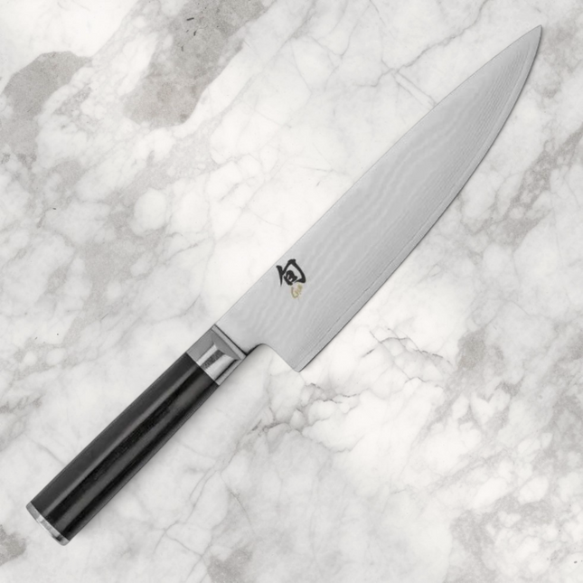 Razor Sharp AZ Shun Classic 8-inch chef's knife with a Damascus steel blade and black D-shaped PakkaWood handle.