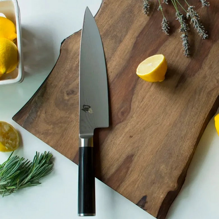 Razor Sharp AZ Shun Classic 8-inch chef's knife with Damascus steel blade and black PakkaWood handle on wood board