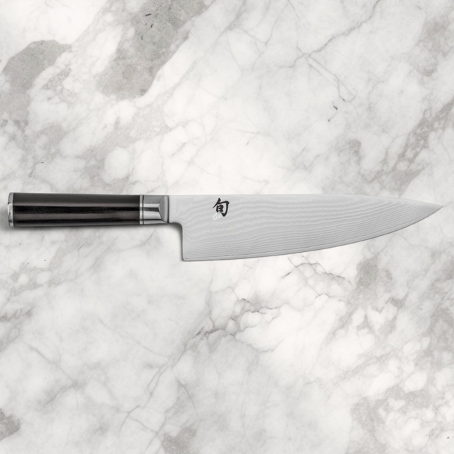 Razor Sharp AZ Shun Classic 8-inch chef's knife with a Damascus steel blade and black D-shaped PakkaWood handle.