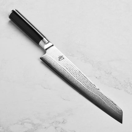 Razor Sharp AZ Shun Classic 9" Master Prep Knife with Damascus blade and black PakkaWood handle.
