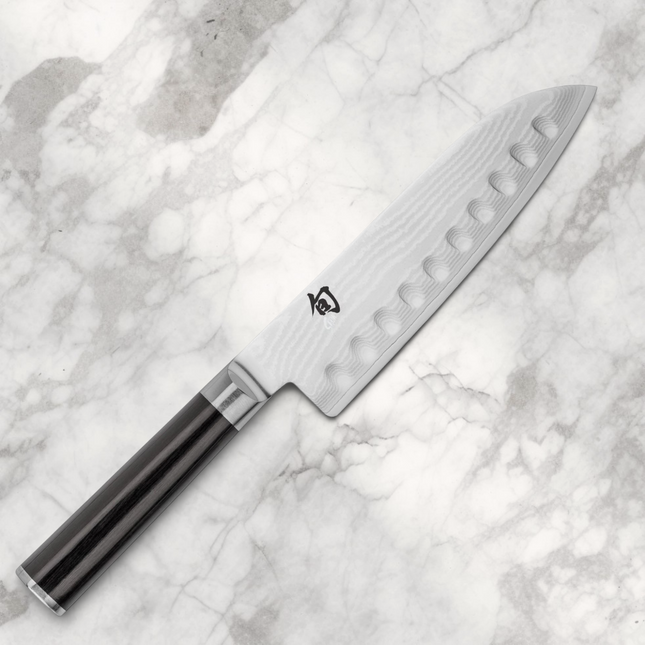 Razor Sharp AZ Shun Classic 7-inch hollow ground santoku knife with Damascus steel blade and black PakkaWood handle.