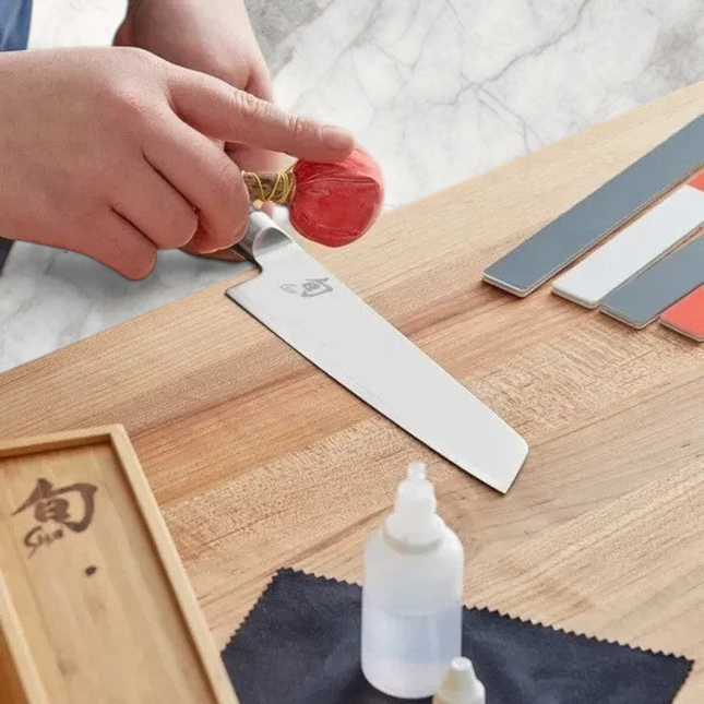 Razor Sharp AZ Shun Knife Care Kit: person cleaning knife with talc ball, polishing sticks, oil, and cloths