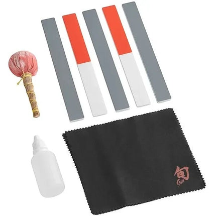 Shun Knife Care Kit with polishing cloths, sticks, oil, talc ball, and bamboo box.