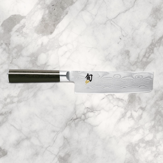 Razor Sharp AZ Shun Classic 6.5-inch Nakiri knife featuring a Damascus steel blade and black ebony PakkaWood handle.