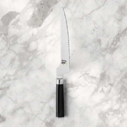Razor Sharp AZ Shun Classic offset bread knife with a serrated Damascus steel blade and black ebony PakkaWood handle.