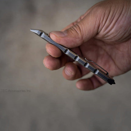 Razor Sharp AZ Ti-Pry titanium pocket pry bar with integrated clip and tungsten carbide glass breaker tip in hand