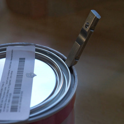 Razor Sharp AZ Ti-Pry titanium pocket pry bar opening a paint can lid with its durable machined edge