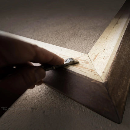 Razor Sharp AZ Ti-Pry titanium pocket pry bar scraping wood on a picture frame corner