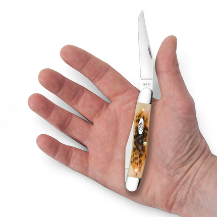 Razor Sharp AZ Case Muskrat pocket knife with peach seed jig amber bone handle held in a person's open palm